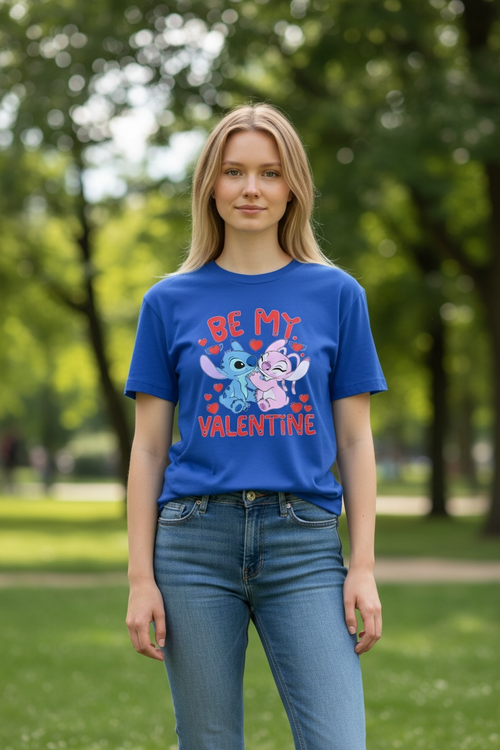 Woman wearing a blue T-shirt with a cute cartoon Valentine design and “Be My Valentine” text, photographed outdoors